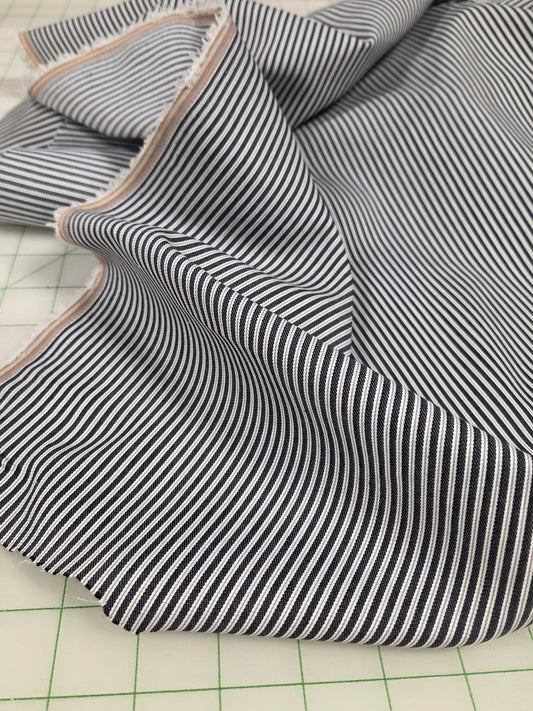 Striped fabric on a cutting mat with grid lines