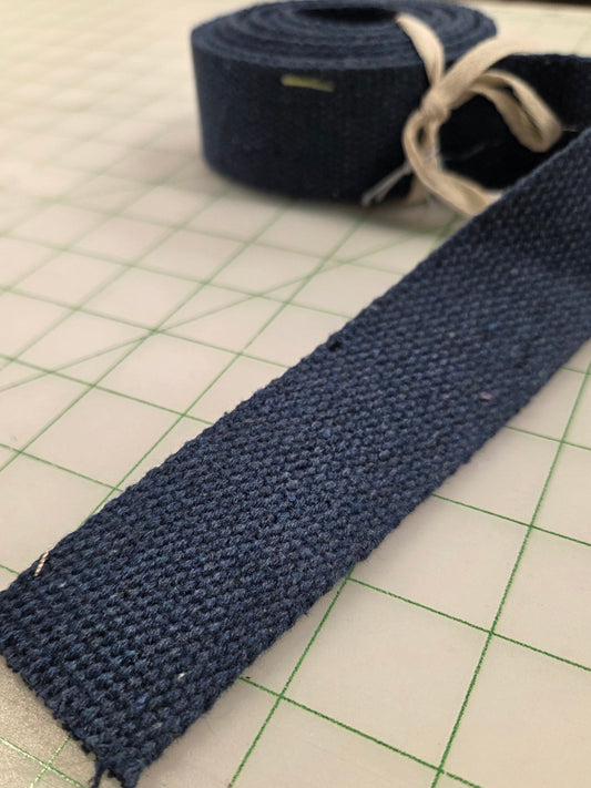 Blue fabric strip on a cutting mat with grid lines