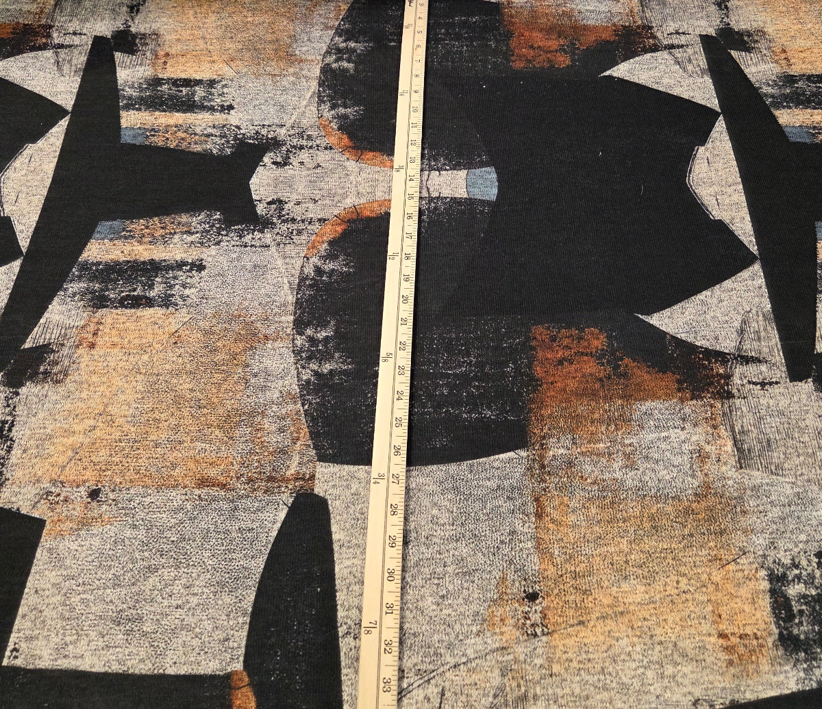 Abstract art piece with geometric shapes and a measuring tape for scale.