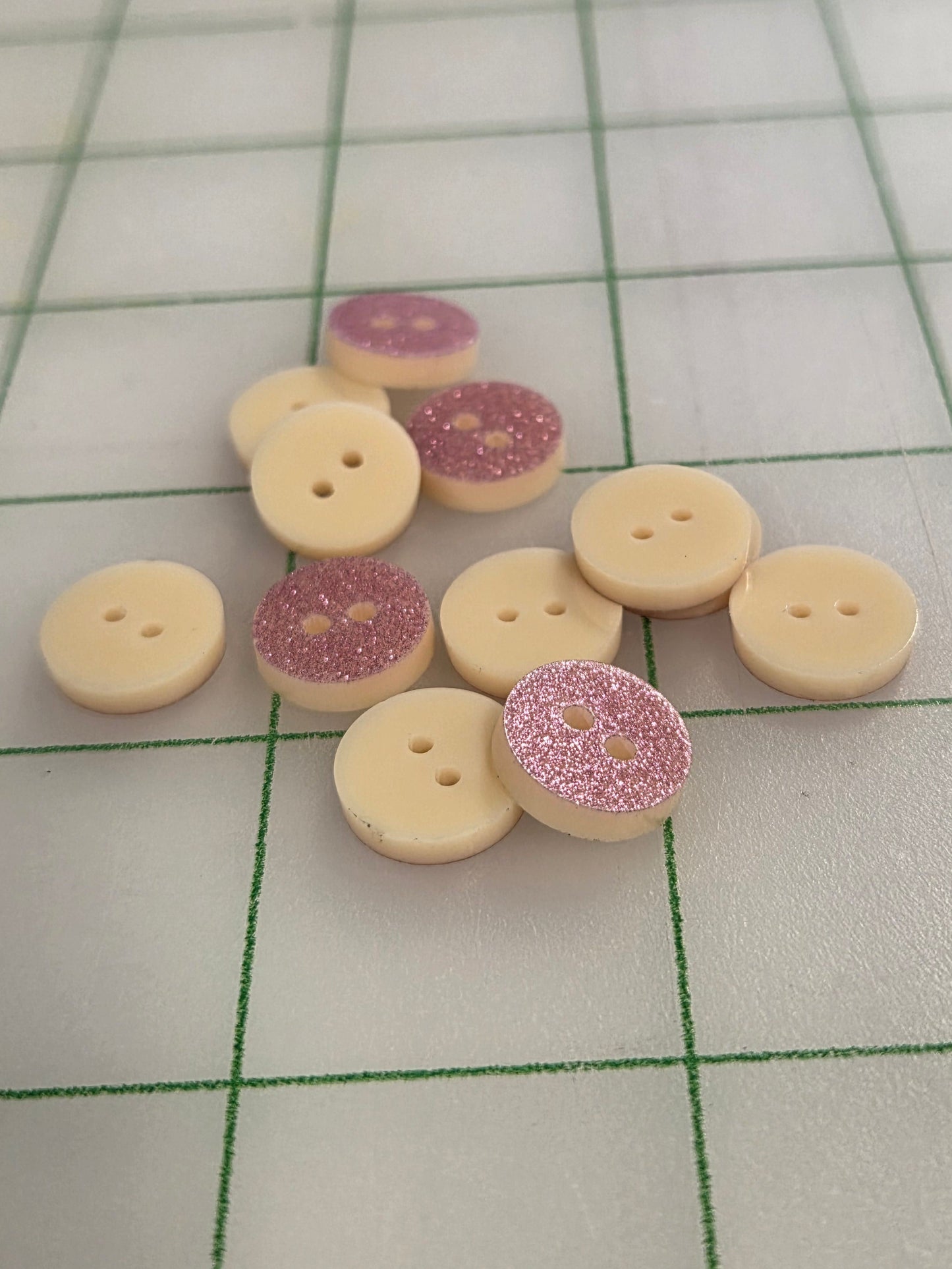 Collection of decorative buttons on a grid background
