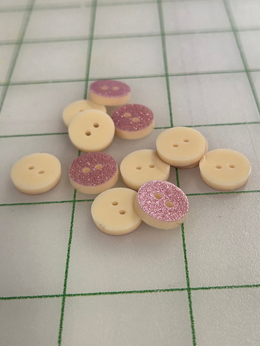 Collection of decorative buttons on a grid background