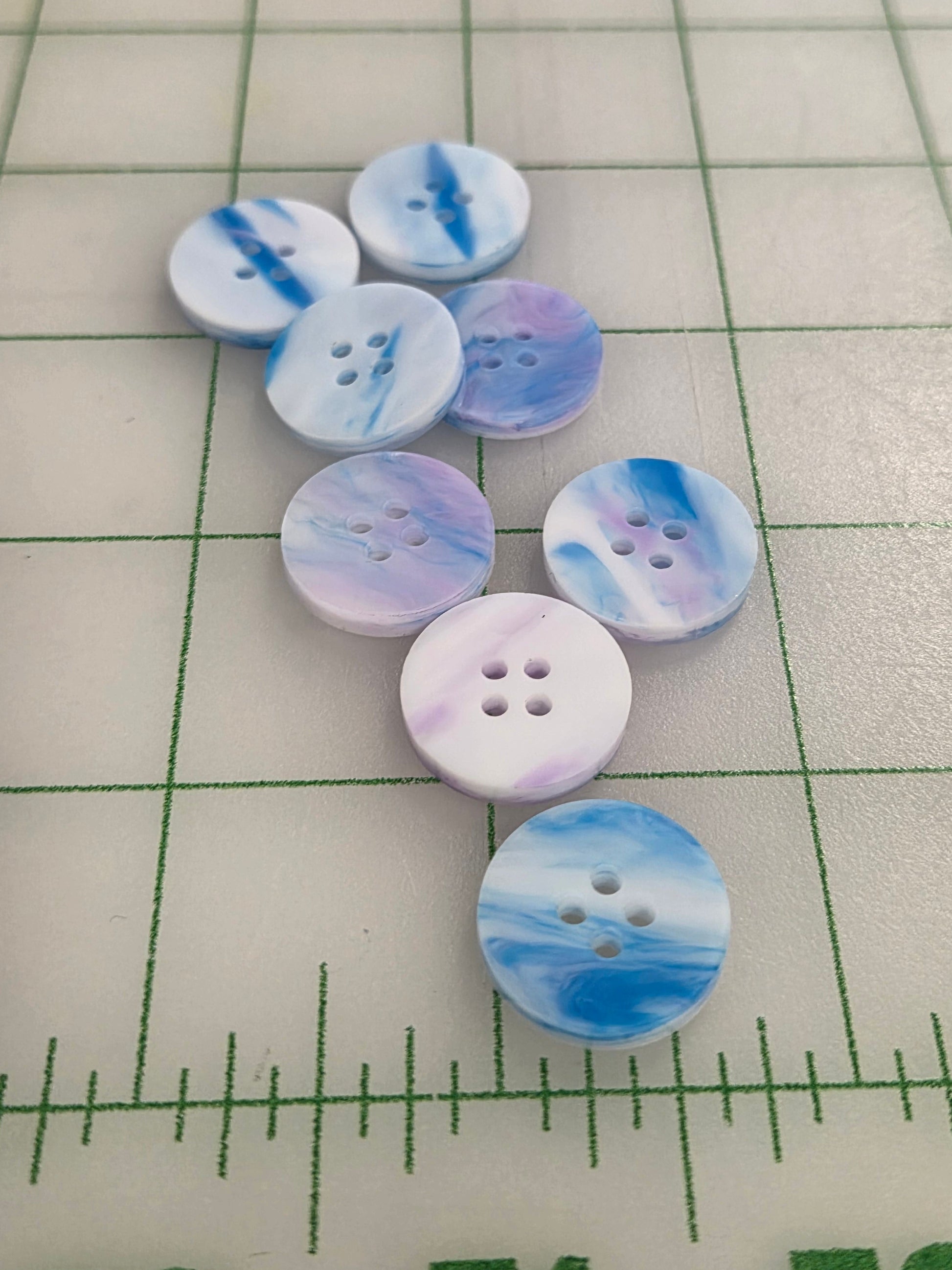 Marbled blue and white buttons on a grid background
