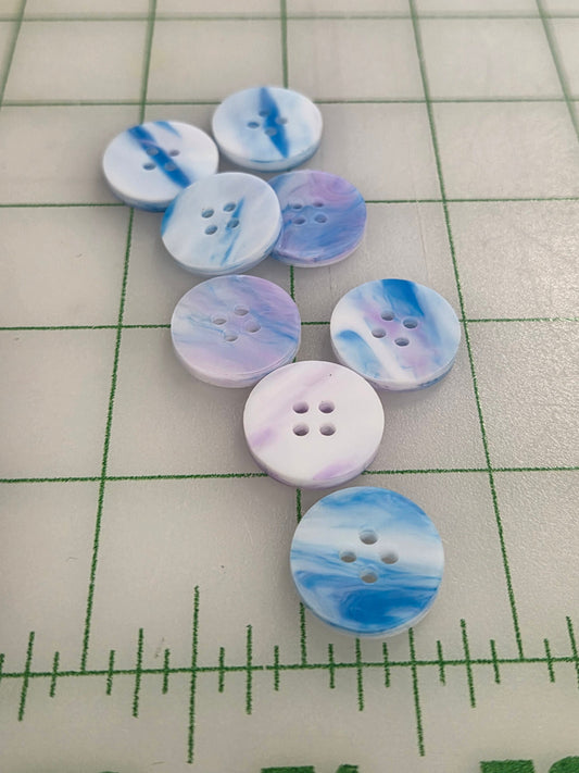 Marbled blue and white buttons on a grid background