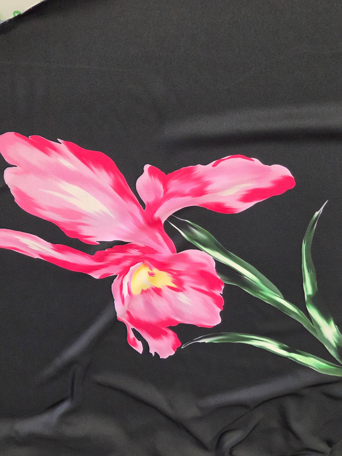 Black jacket with a pink flower design on a blurred background