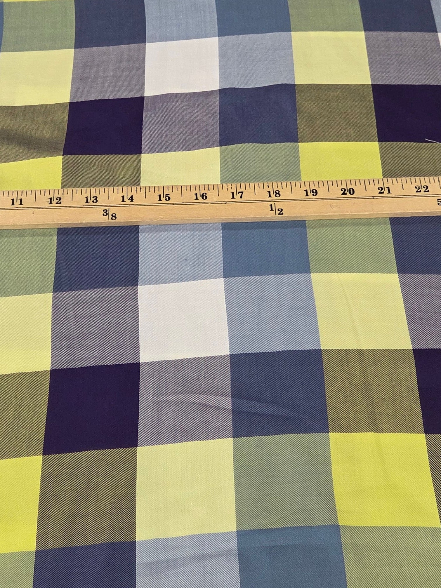 Plaid fabric with a measuring tape on a grid background