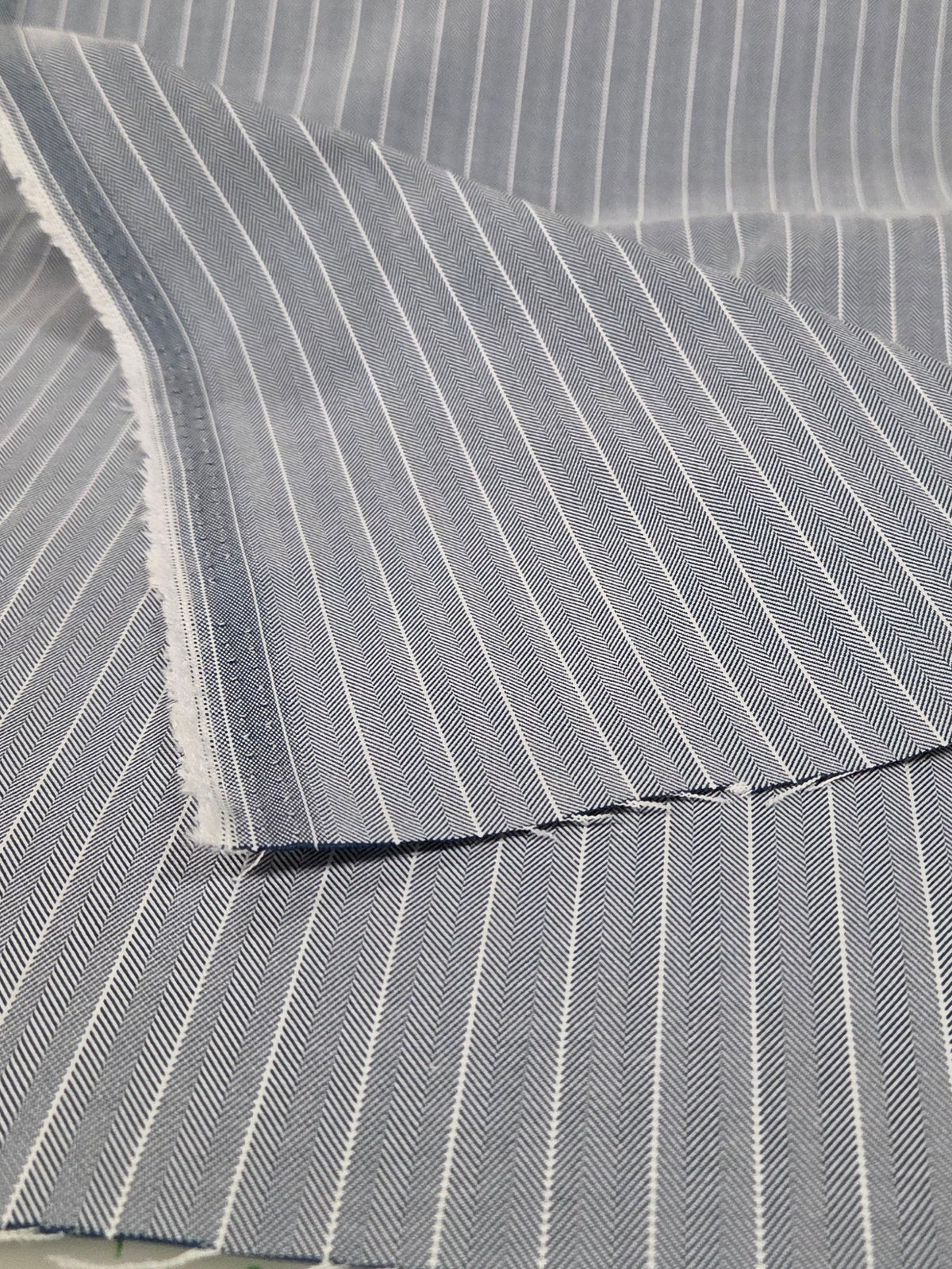Gray striped fabric with measurements on a hanger