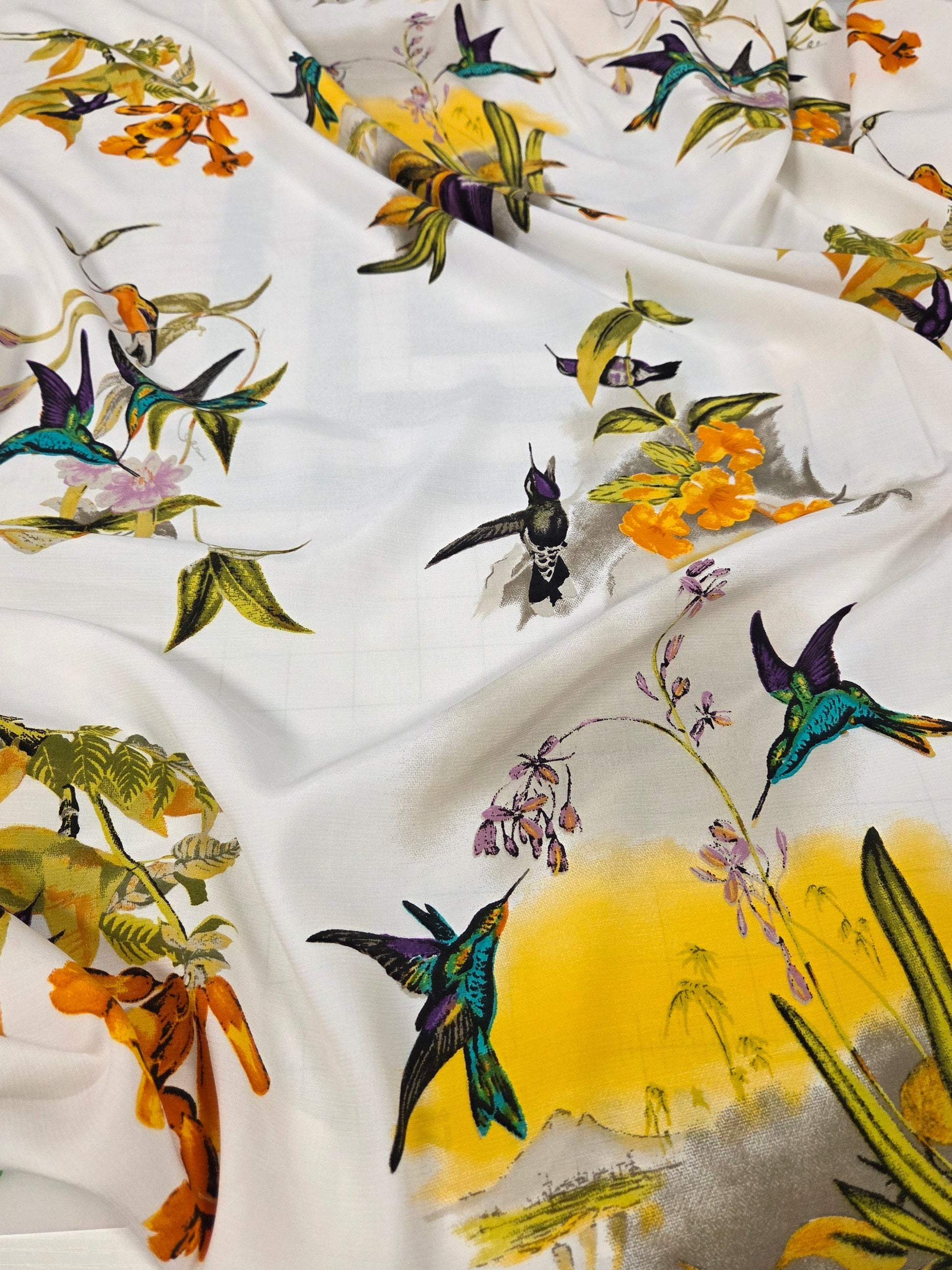 Fabric with colorful bird and floral pattern on a white background