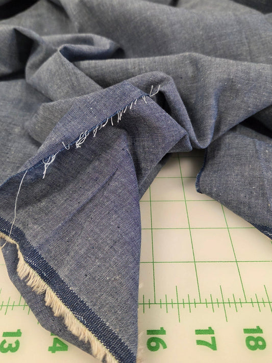 Denim fabric with a ruler showing measurements on a white background