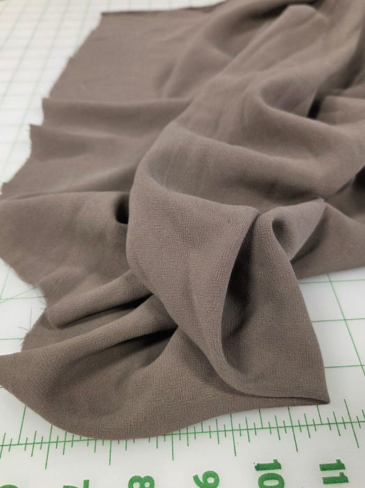Brown fabric on a cutting mat with measurements