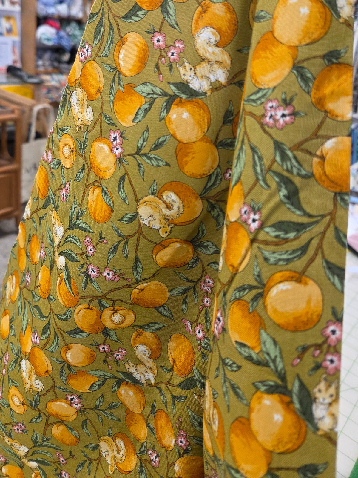 Fabric with orange and floral pattern on a table
