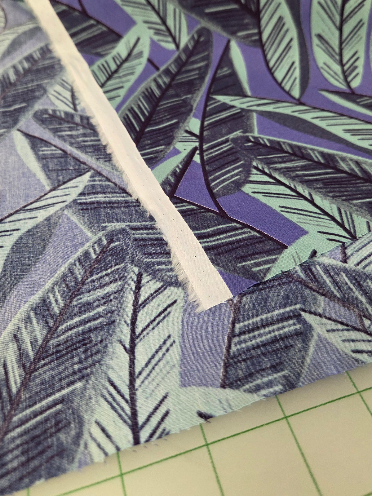 Fabric with a leaf pattern on a cutting mat