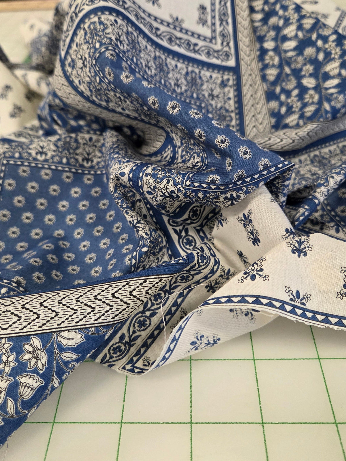Blue and white patterned fabric on a cutting mat