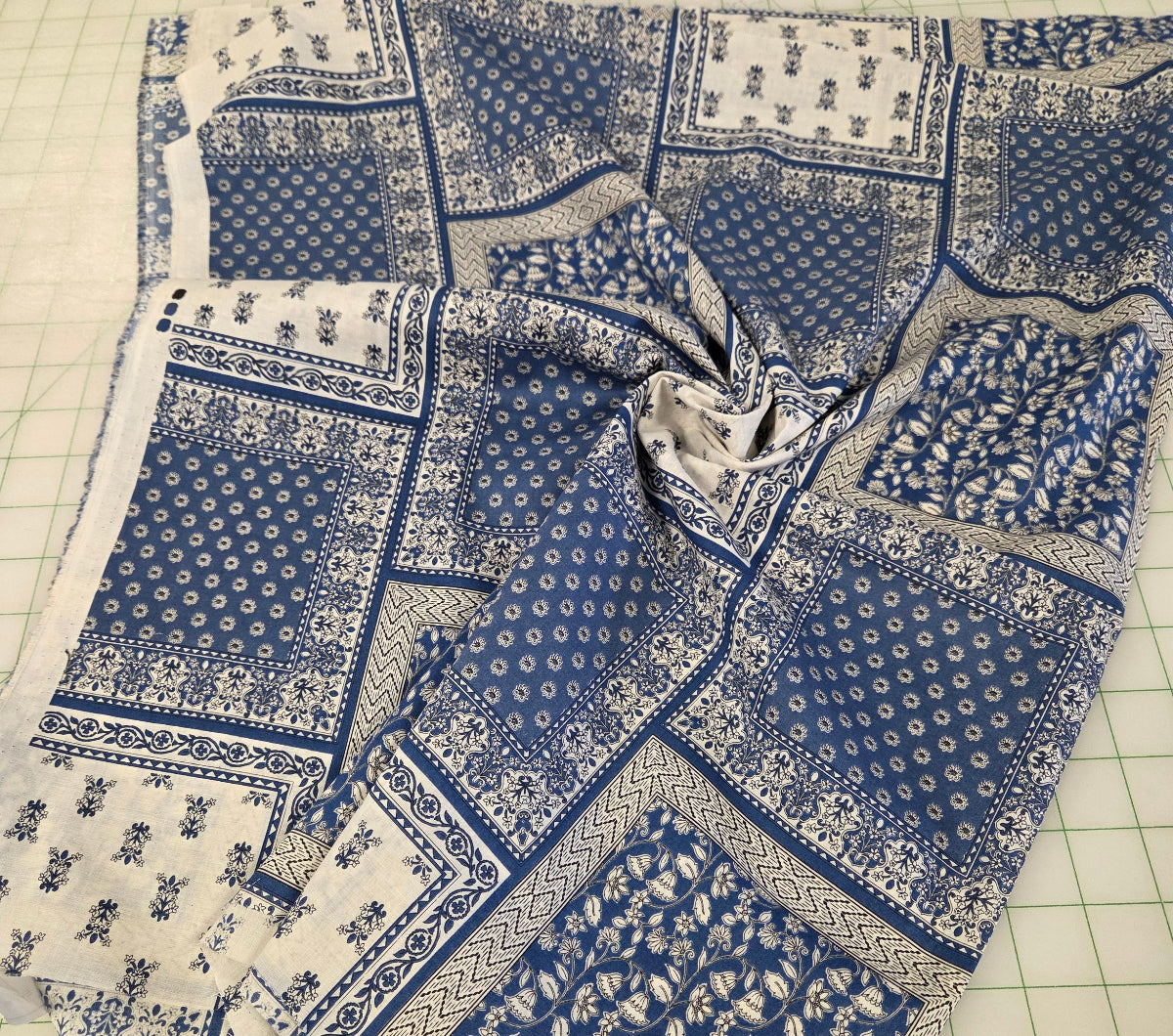 Blue and white patterned fabric on a cutting mat