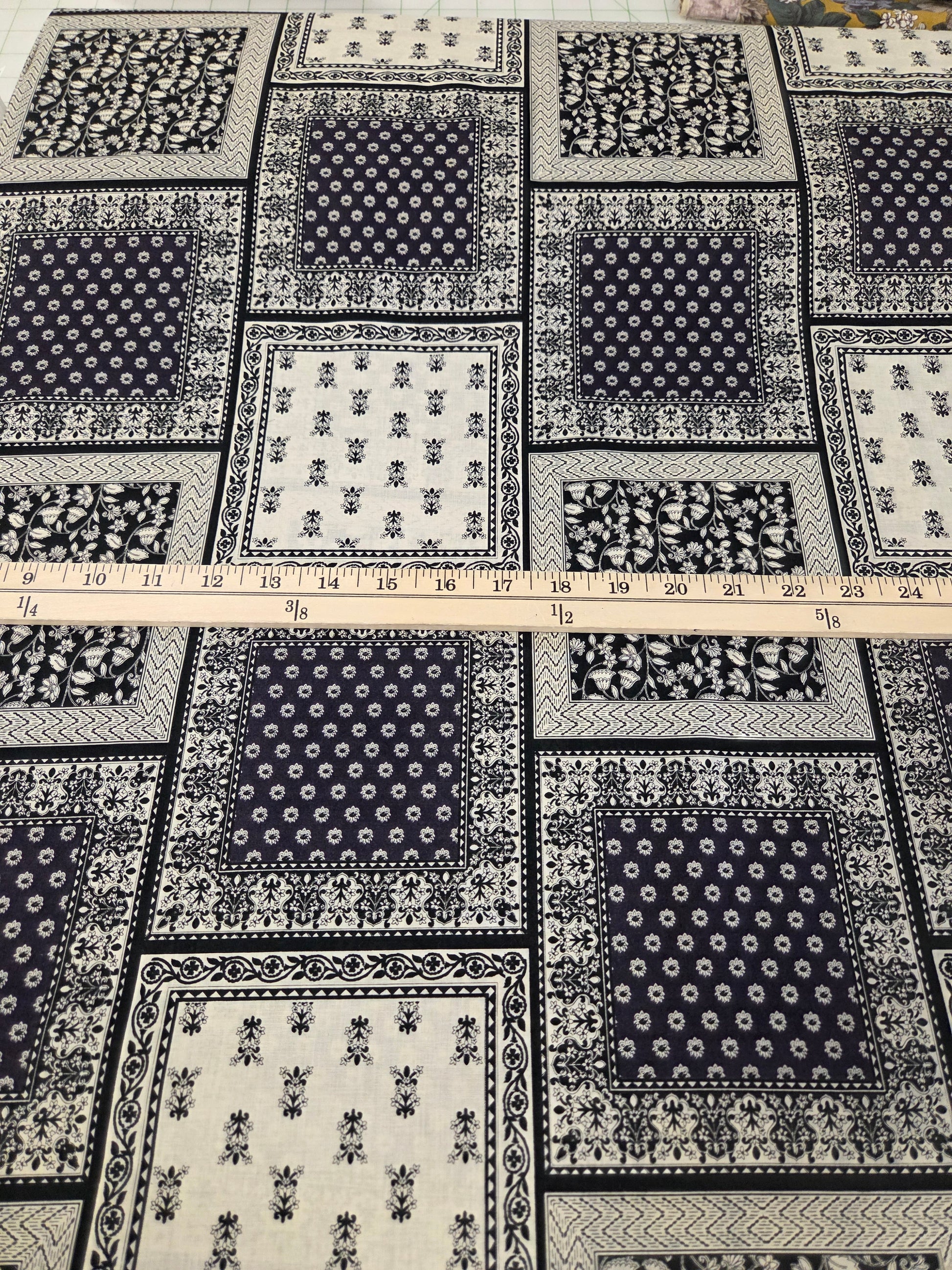 Patterned fabric with a ruler for scale on a white background