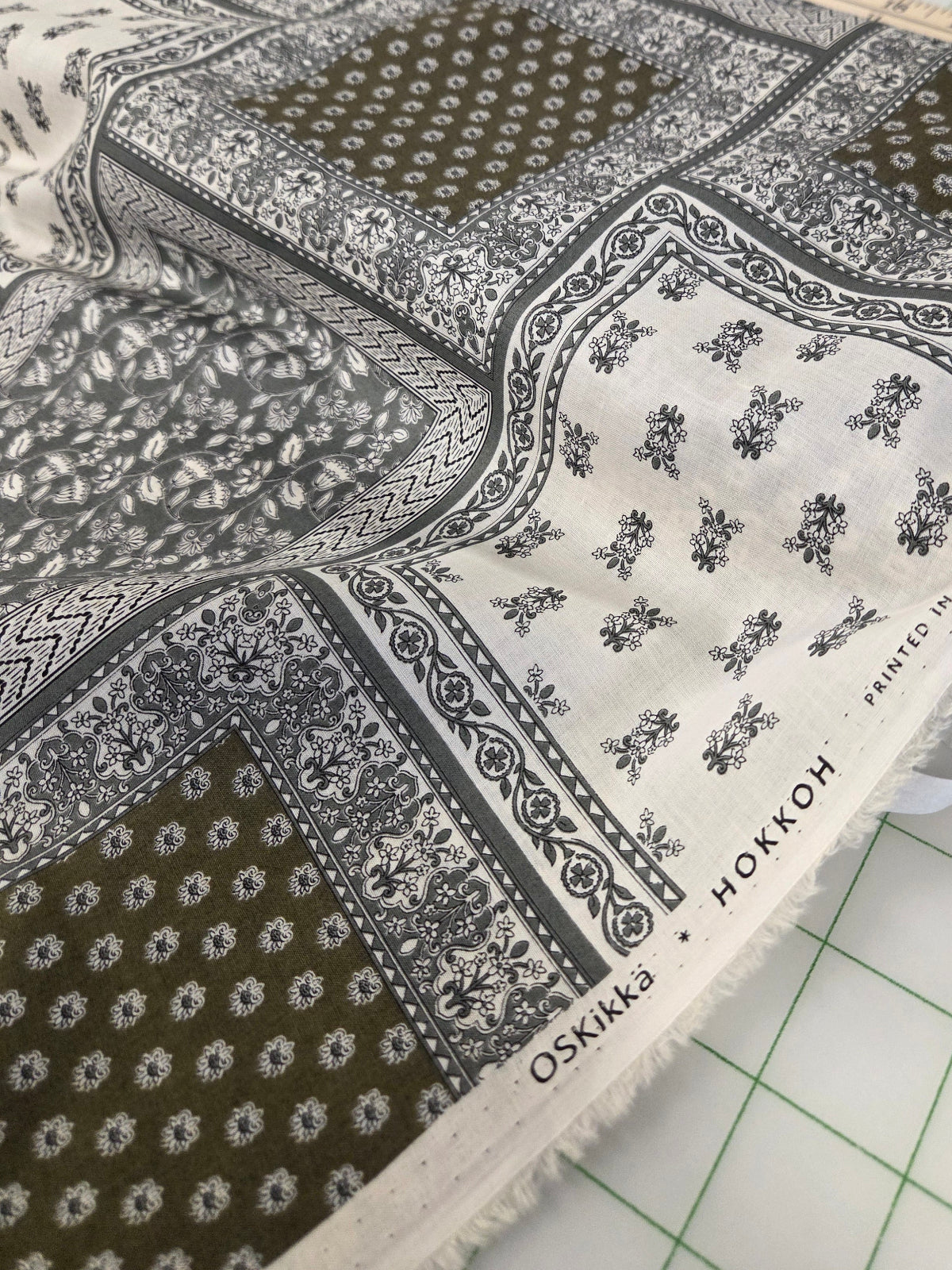 Fabric with green and white pattern on a cutting mat