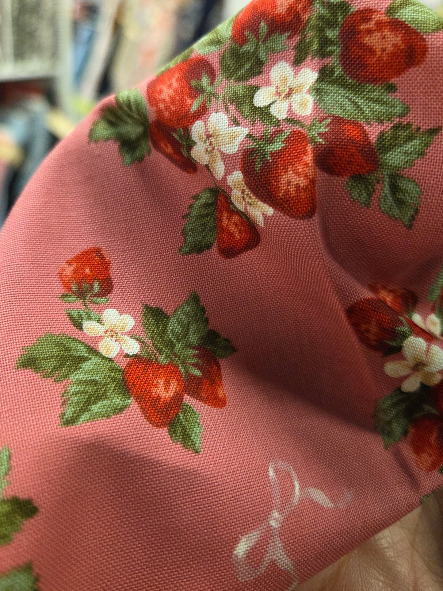 Pink fabric with strawberry and leaf pattern