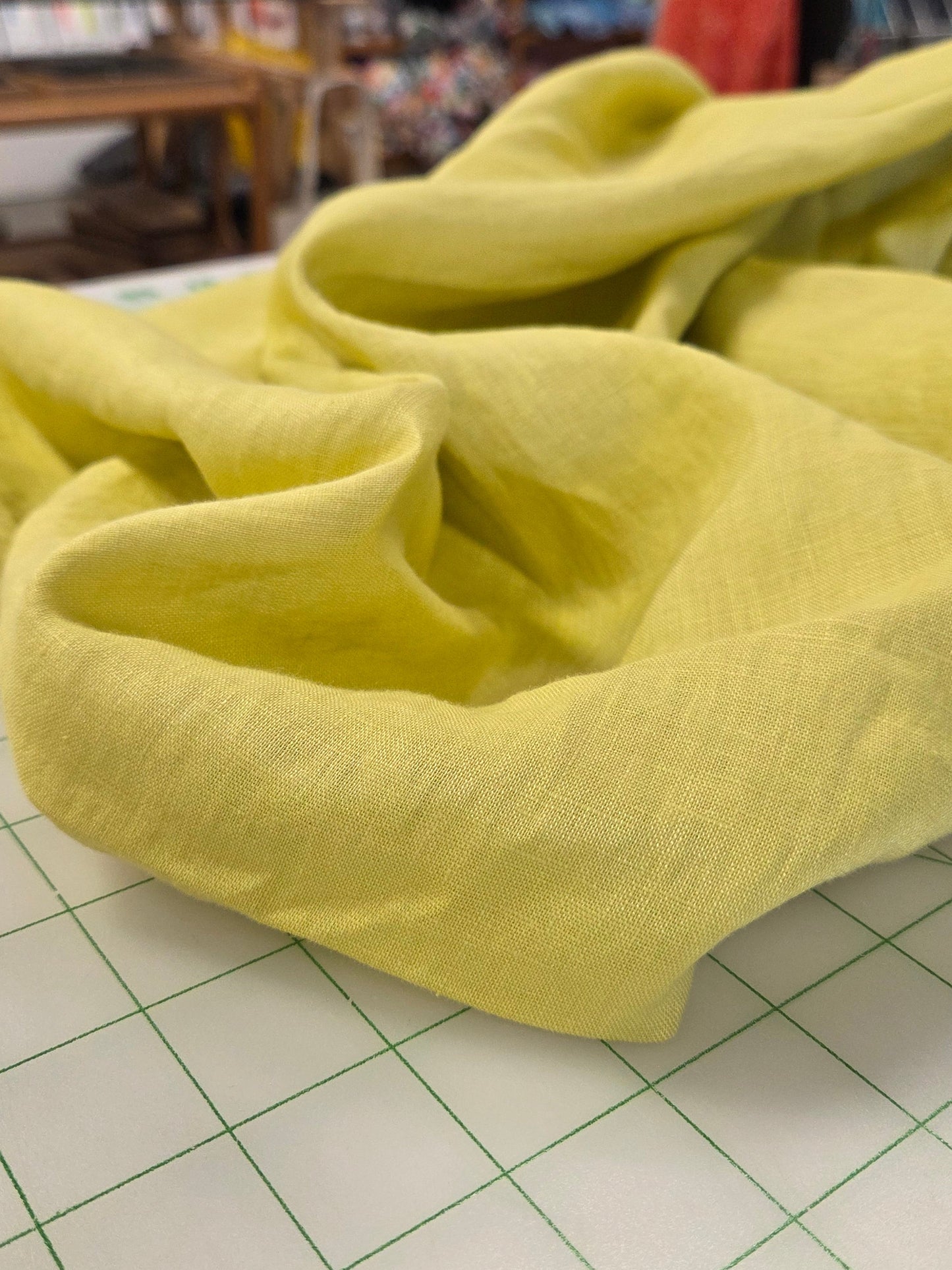 Yellow fabric on a grid surface with a store setting in the background