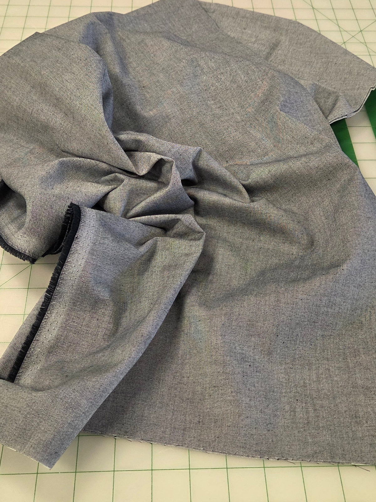 Gray fabric on a cutting mat with a ruler and Kangaroo branding.