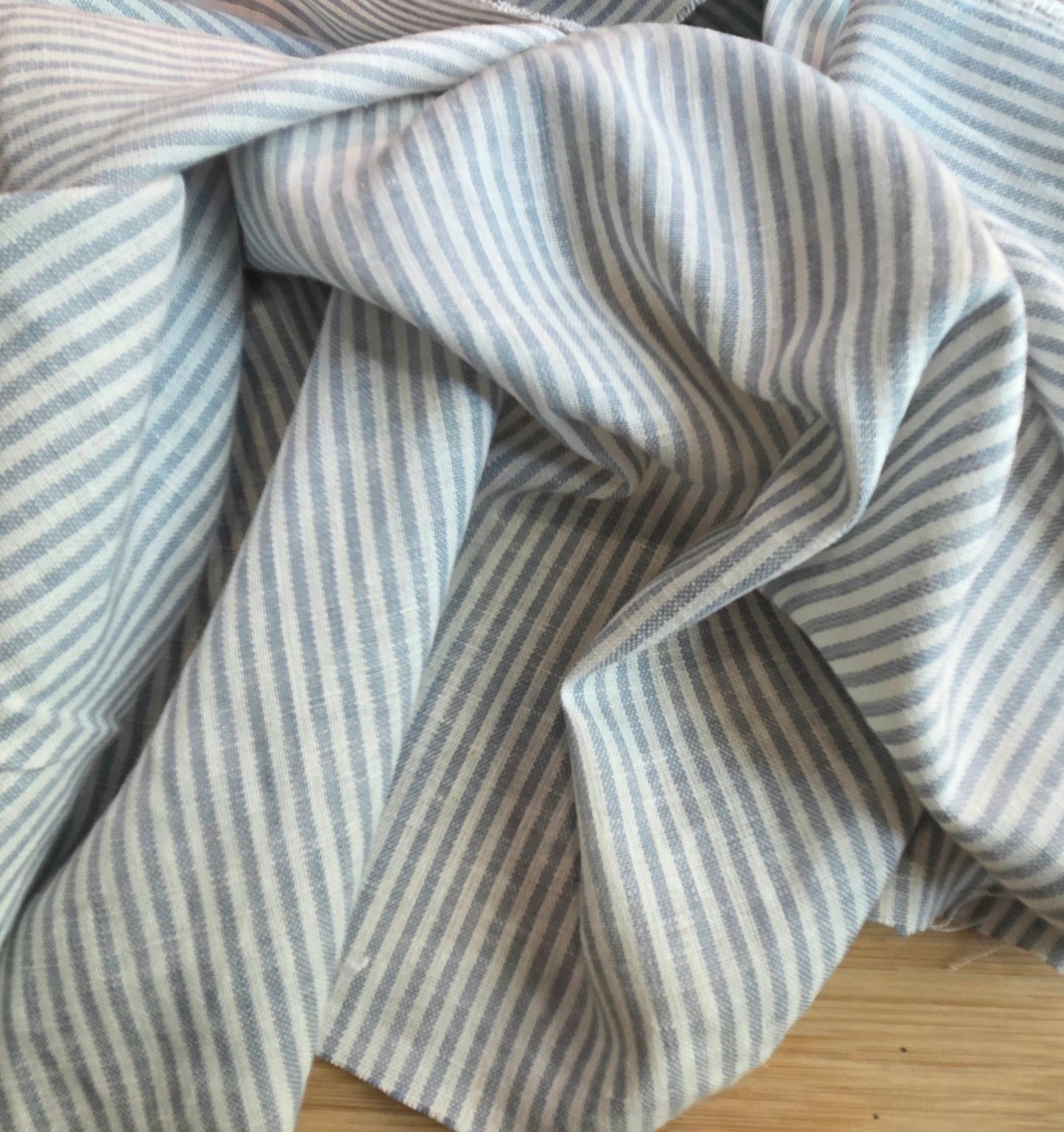 Close-up of blue and white striped fabric on a wooden surface