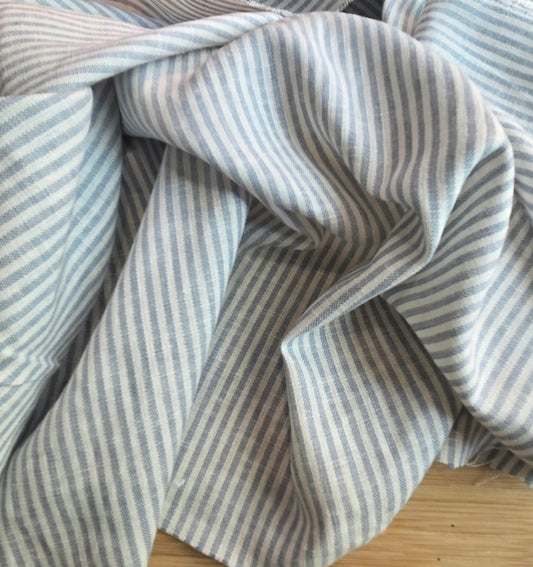 Close-up of blue and white striped fabric on a wooden surface