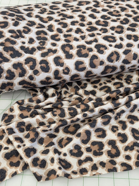 Leopard print fabric on a grid background