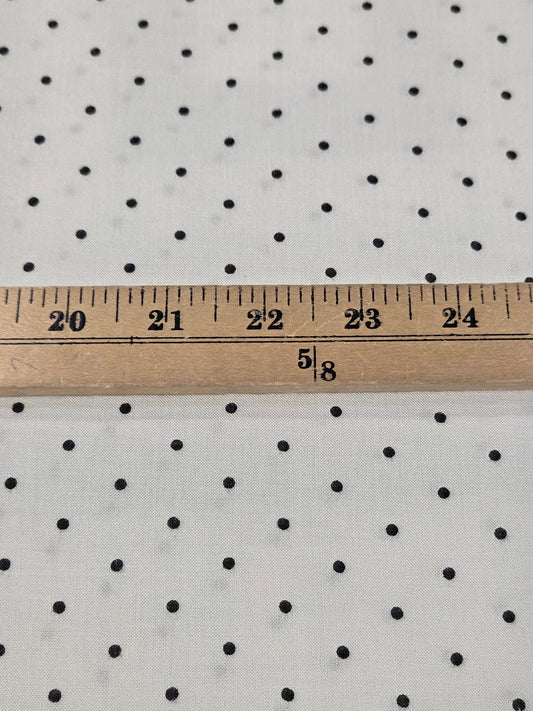 rayon challis dot woven with micro black dots on an ivory rayon