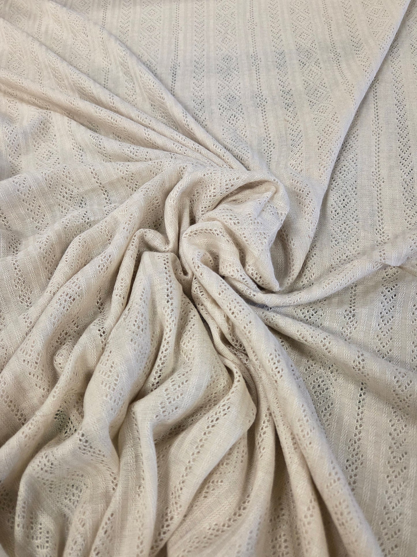 beige pointelle fabric by the yard for clothmaking. Crochet like sweater jersey knit