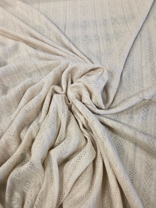 beige pointelle fabric by the yard for clothmaking. Crochet like sweater jersey knit
