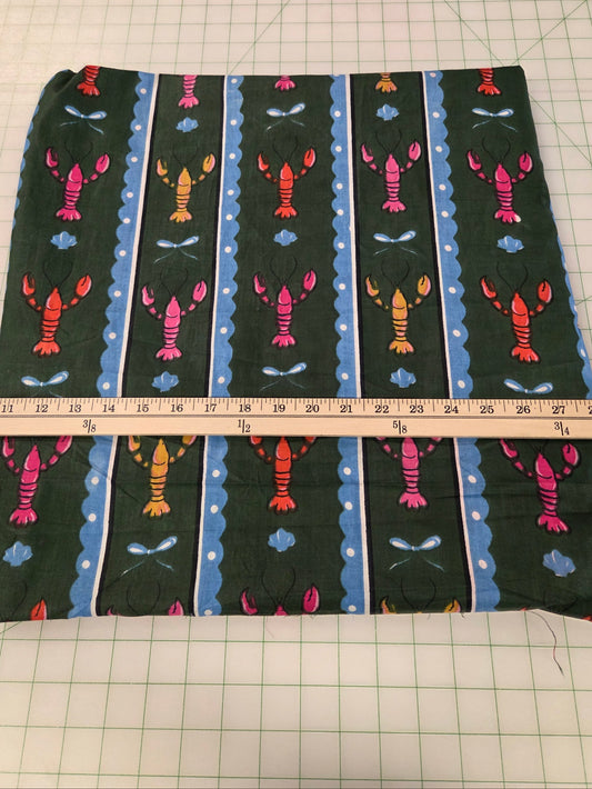 A square piece of fabric with a lobster pattern, laid flat on a green gridded cutting mat with a wooden ruler showing its dimensions. LA Finch Fabrics by the yard ,retail US Shipping
