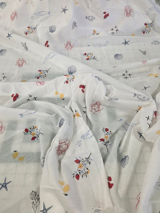 White sheer fabric printed with a colorful nautical and floral pattern, draped to show its texture and print.