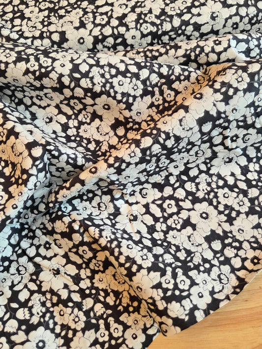 Navy with a dense white and floral print, draped to show its texture and pattern. LA Finch Fabrics Retail Fabric by the yard