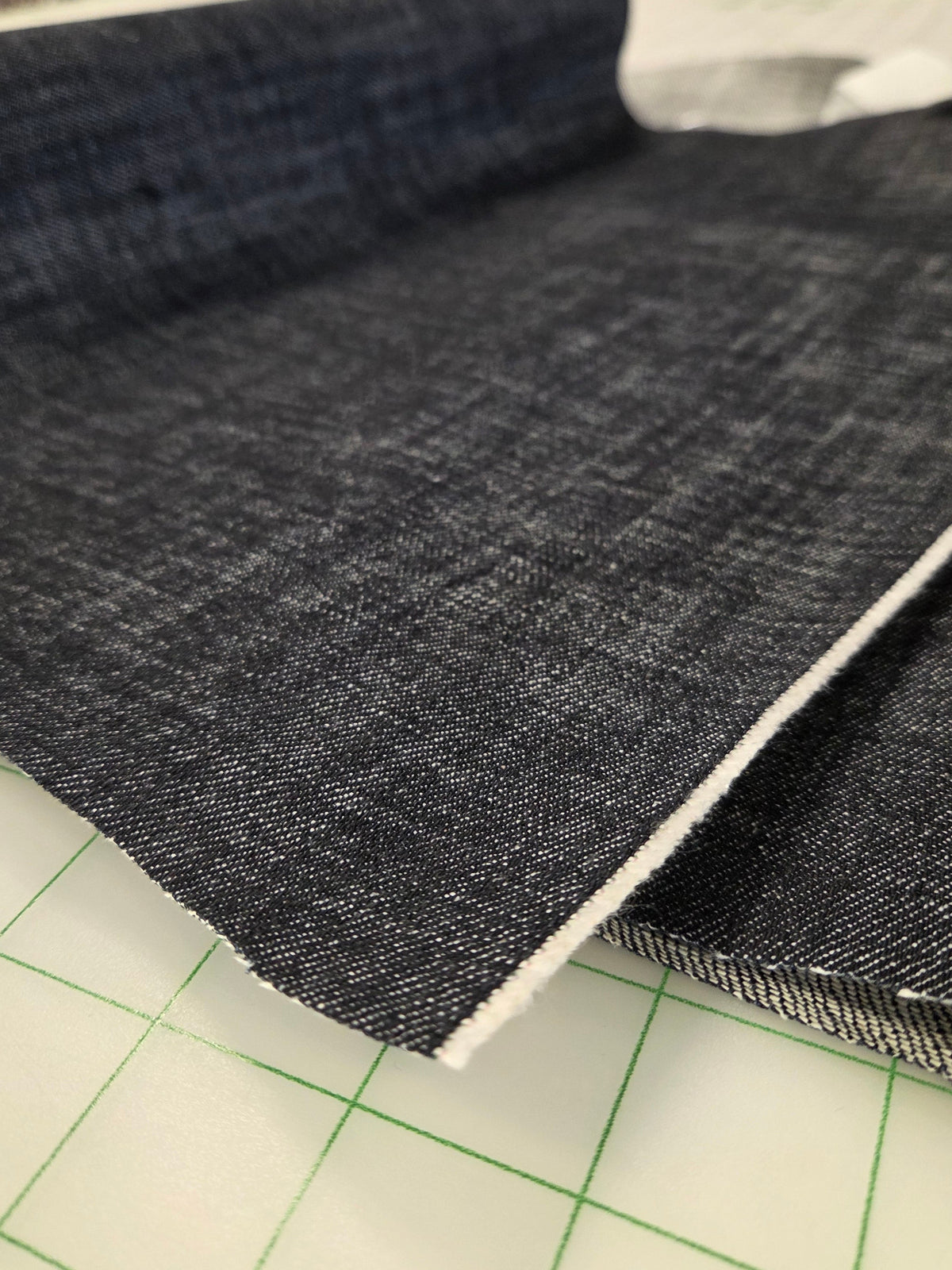 Cone Mills close up of denim fabric sold by the yard. Cross hatch Indigo Dark Denim foir sewing your own garments