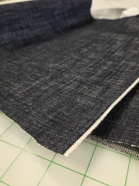 Cone Mills close up of denim fabric sold by the yard. Cross hatch Indigo Dark Denim foir sewing your own garments
