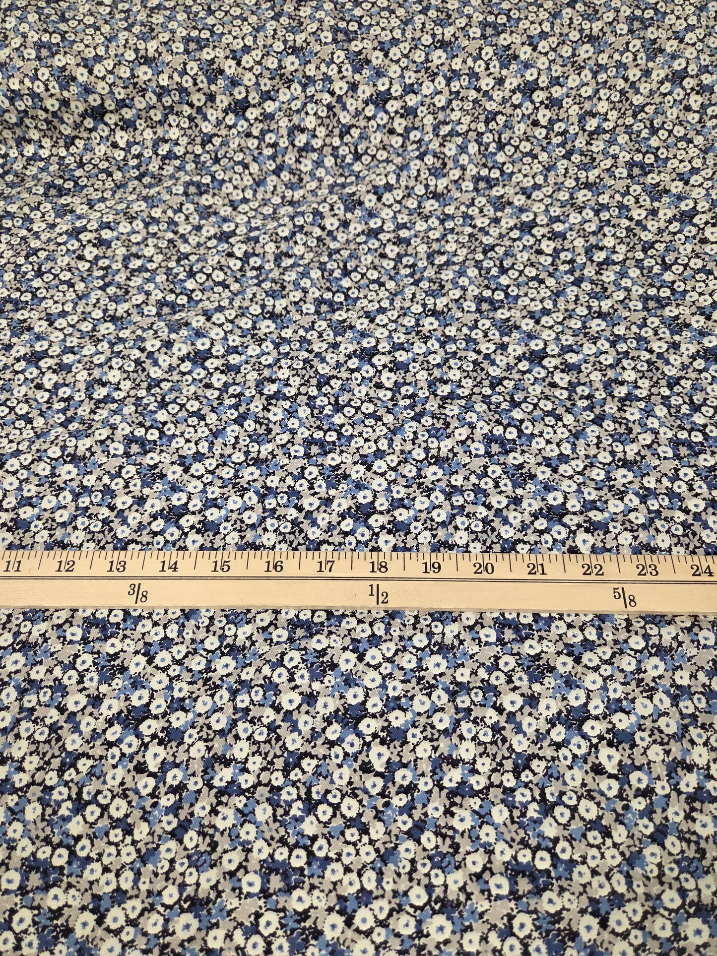 Floral patterned fabric with a ruler for scale on a white background. Kokka Fabric NCA-92770 cotton floral twill weave woven
