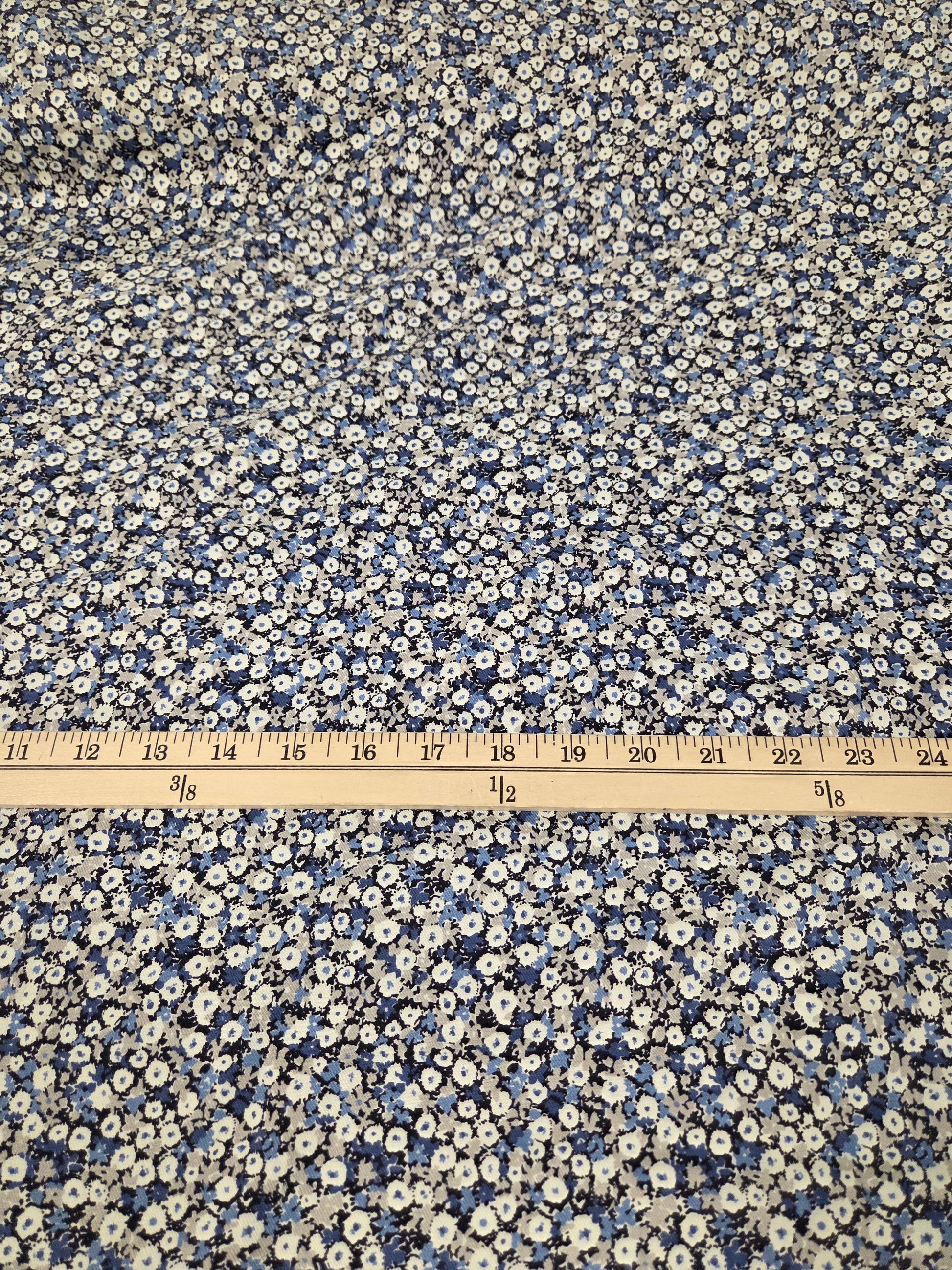 Floral patterned fabric with a ruler for scale on a white background. Kokka Fabric NCA-92770 cotton floral twill weave woven