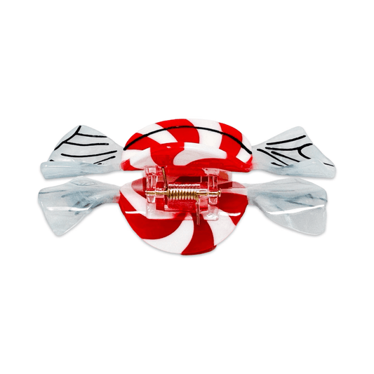 A candy-shaped hair claw clip with a red and white striped center and translucent clear wings with black line details, shown on a plain white background.