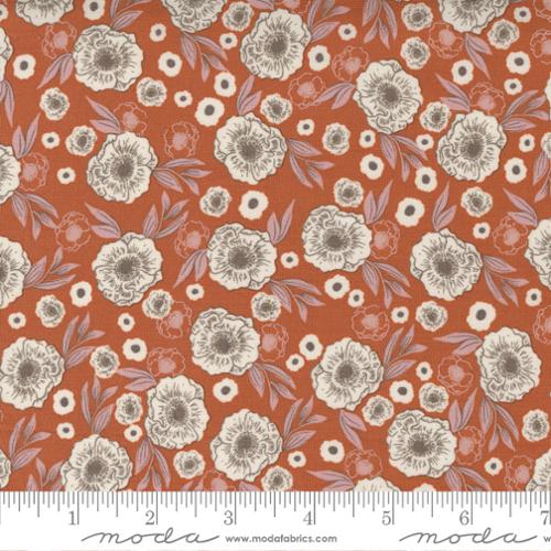 Floral pattern fabric with a ruler at the bottom for scale, on a red background.