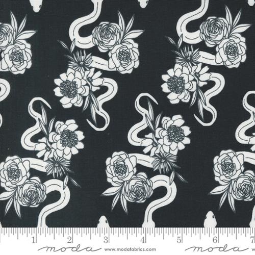 Black fabric with white snake and floral pattern, featuring Moda label at the bottom.