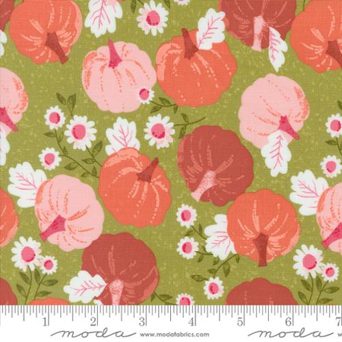 Fabric pattern with pumpkins and flowers on a green background, featuring Moda label.