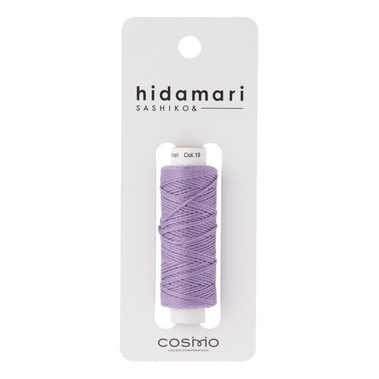 Purple thread spool in a 'hidamari' packaging on a white background