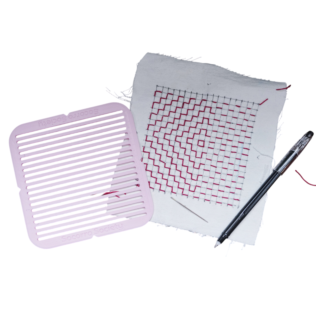 Grid-patterned paper with a pen on a white background