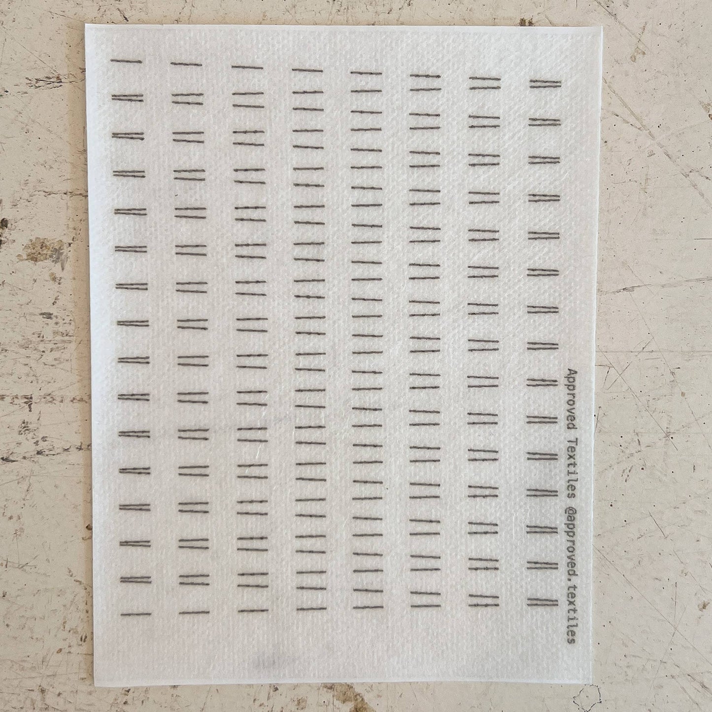 Sheet of black text samples on a textured beige background