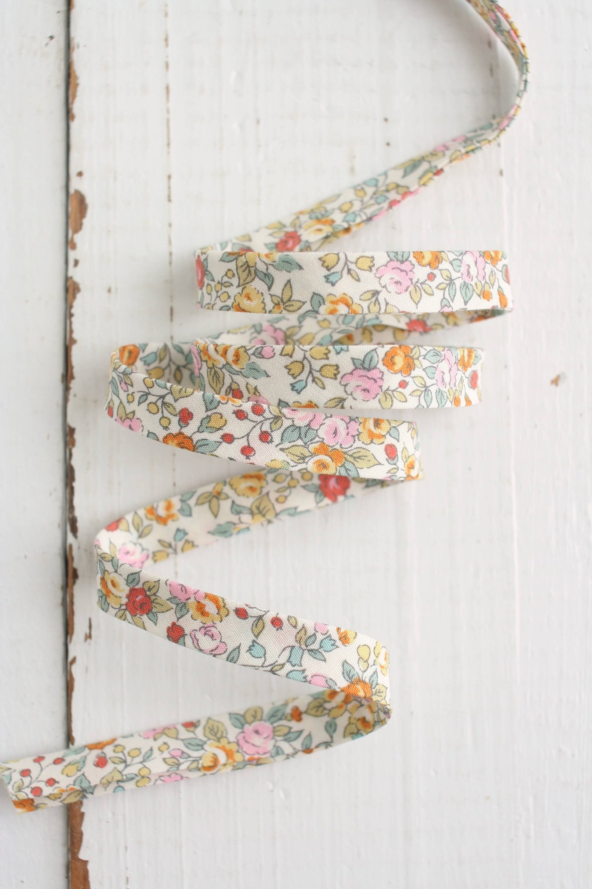Floral ribbon on a white wooden background