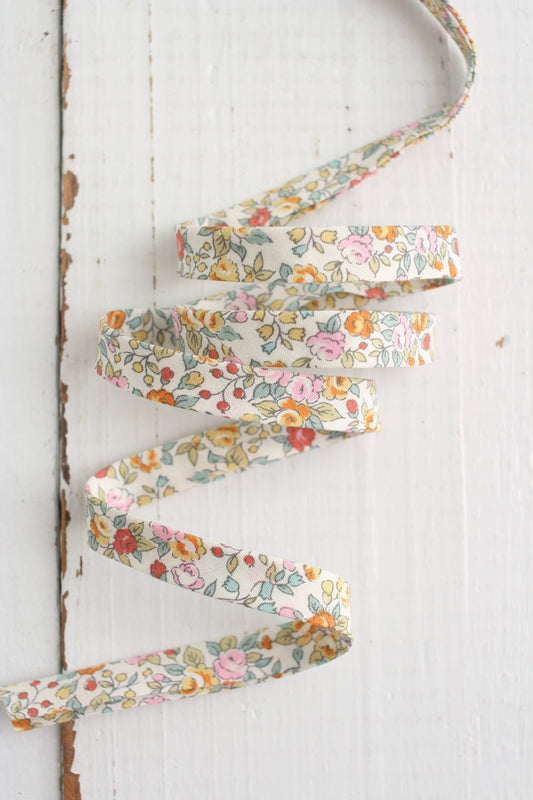 Floral ribbon on a white wooden background