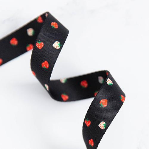 Black ribbon with strawberry pattern on a white background