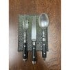 Set of silver cutlery on a textured black surface