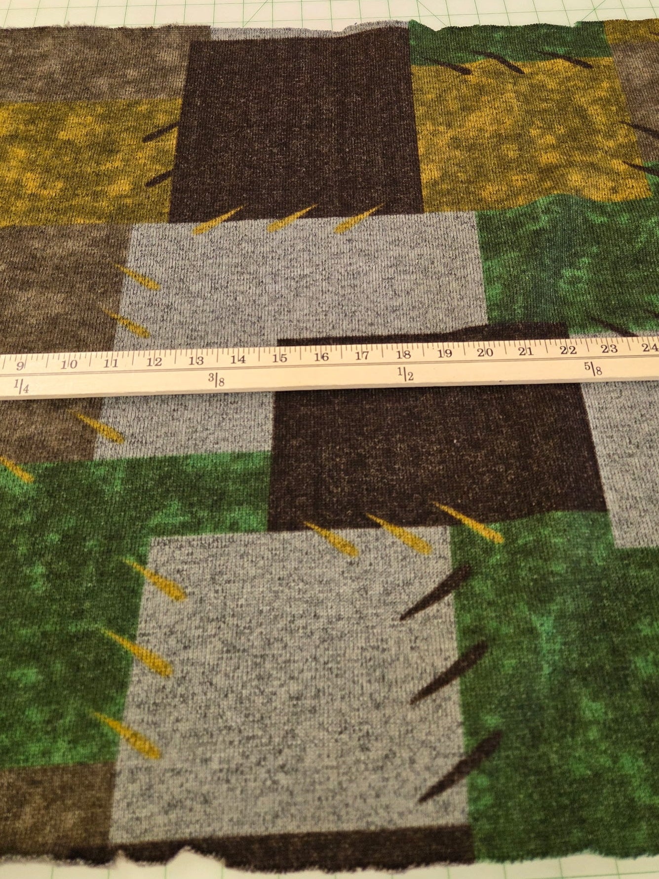Textured fabric with a ruler for scale on a grid background