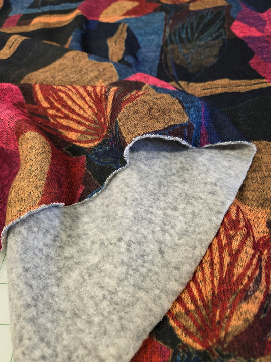 Colorful fabric with a floral pattern on top of gray fabric