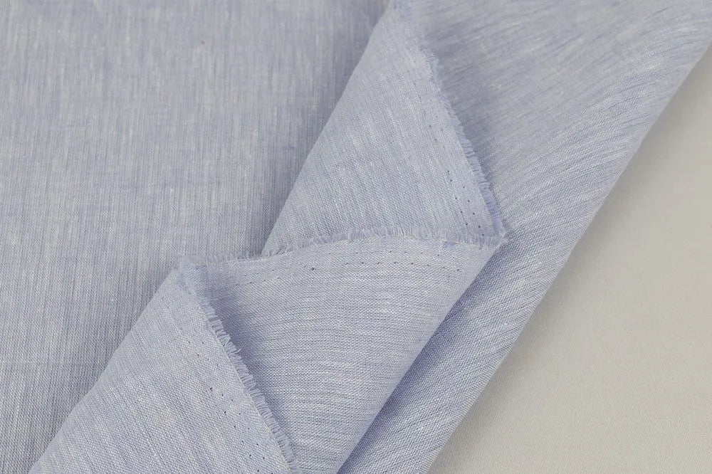 Close-up of light blue violet linen with a subtle pattern on a neutral background