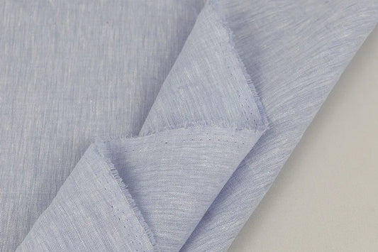 Close-up of light blue violet linen with a subtle pattern on a neutral background